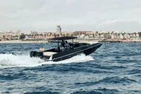 Speedboat cruising on the ocean near a coastal city, FB Design Fabio Buzzi FB 38/19 S, 2008.