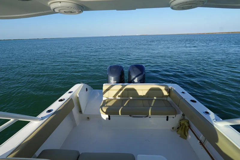  Yacht Photos Pics 2016 Pursuit ST 310 Sport boat with twin engines on open water.