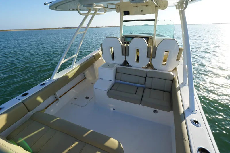  Yacht Photos Pics 2016 Pursuit ST 310 Sport boat interior with seating, on calm water.