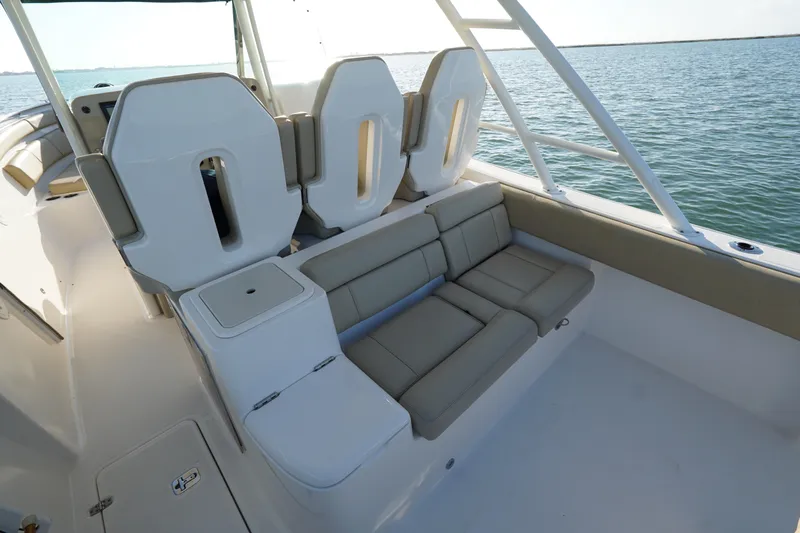  Yacht Photos Pics 2016 Pursuit ST 310 Sport boat interior with cushioned seating and ocean view.