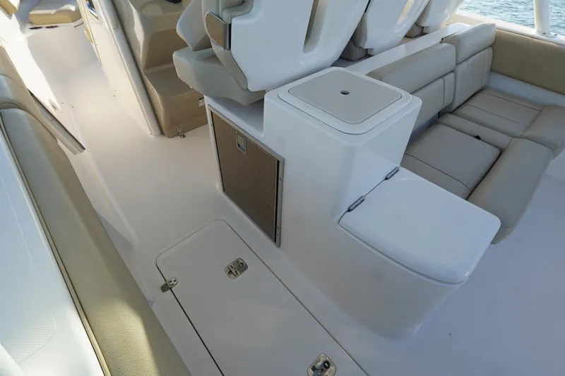  Yacht Photos Pics 2016 Pursuit ST 310 Sport boat interior with seating and storage compartments.