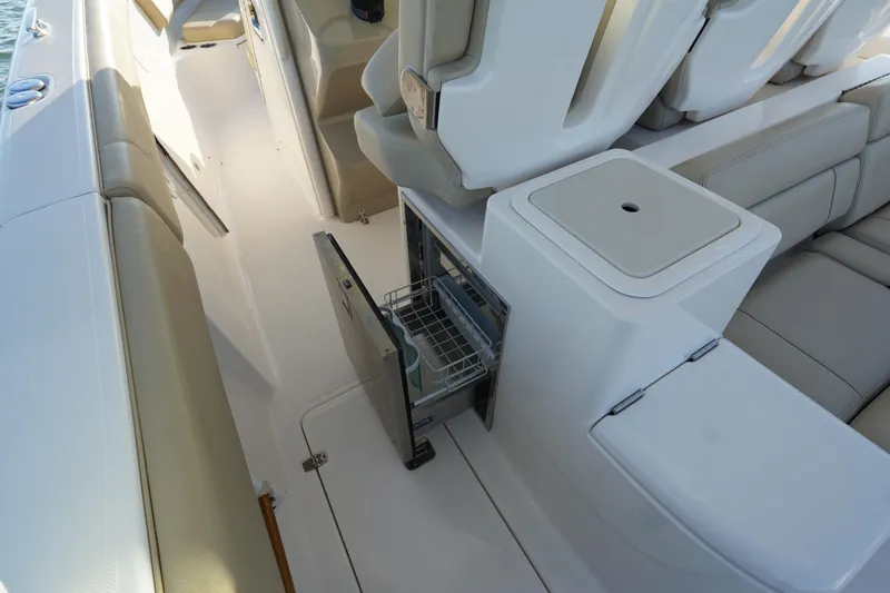  Yacht Photos Pics 2016 Pursuit ST 310 Sport boat interior with open storage compartment and seating.