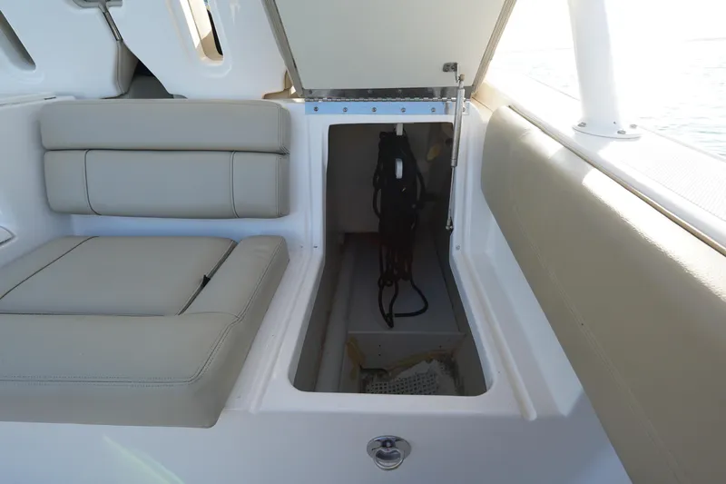  Yacht Photos Pics 2016 Pursuit ST 310 Sport boat storage compartment with cushioned seating.