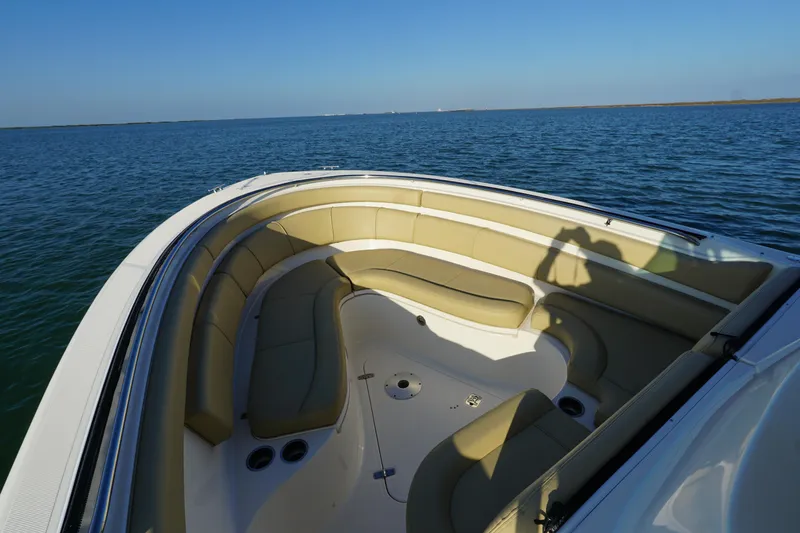  Yacht Photos Pics 2016 Pursuit ST 310 Sport boat with spacious seating on calm water.