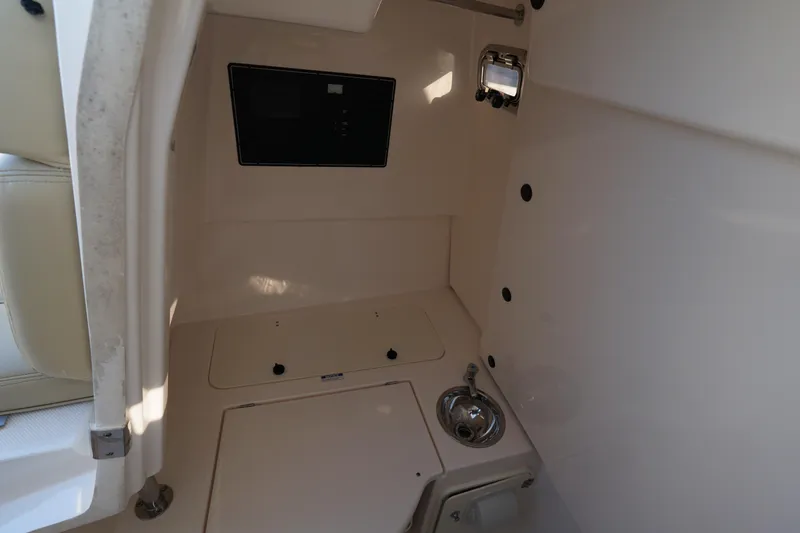  Yacht Photos Pics Interior of 2016 Pursuit ST 310 Sport boat, featuring a compact sink and storage area.