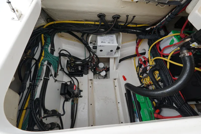  Yacht Photos Pics Engine compartment of a 2016 Pursuit ST 310 Sport boat, showcasing wiring and components.