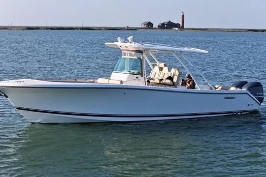  Yacht Photos Pics 2016 Pursuit ST 310 Sport boat on calm water with distant lighthouse.