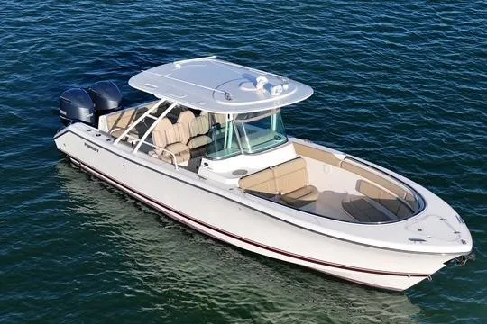 Yacht Photos Pics 2016 Pursuit ST 310 Sport boat on water, featuring dual engines and spacious seating.