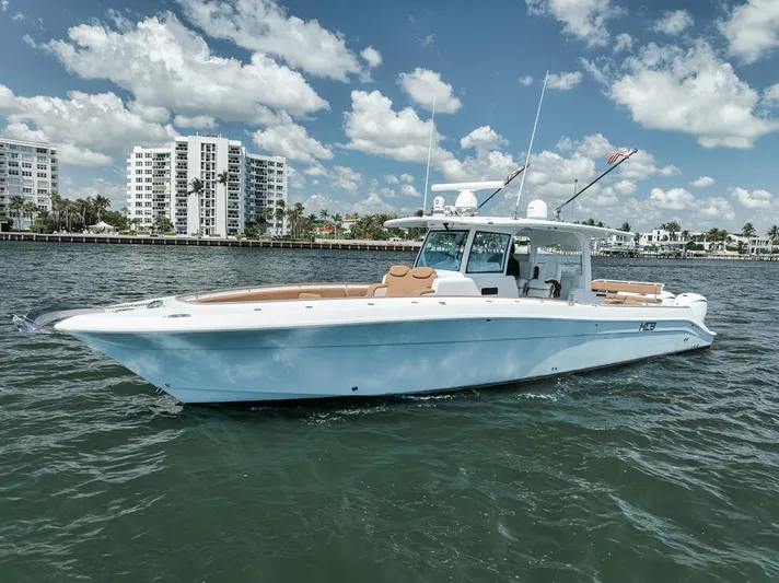 Mo Jack Yacht Photos Pics 2022 HCB Lujo boat cruising on water with cityscape background.