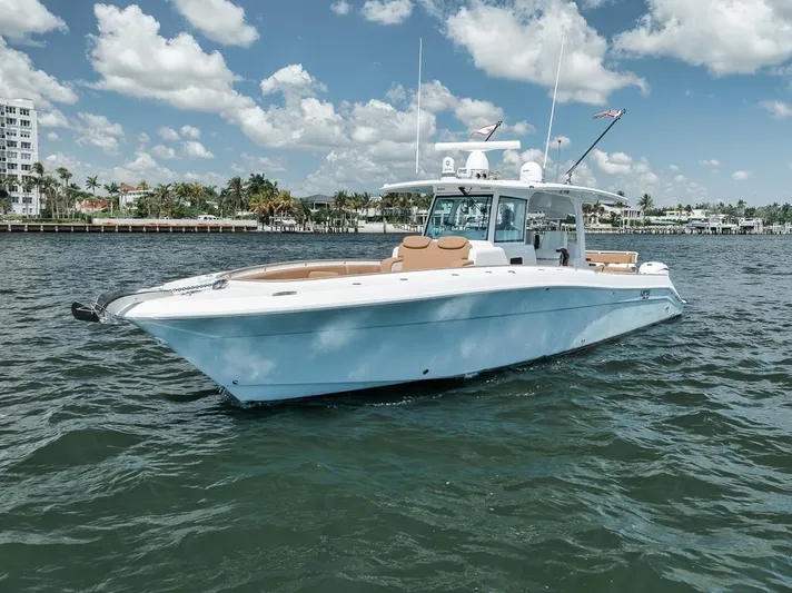 Mo Jack Yacht Photos Pics 2022 HCB Lujo boat on water under blue sky with clouds.