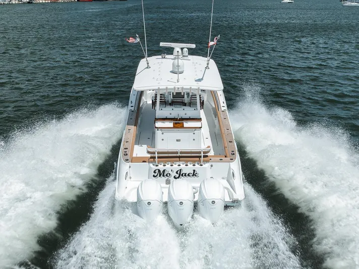 Mo Jack Yacht Photos Pics 2022 HCB Lujo boat cruising on water, rear view with powerful engines.