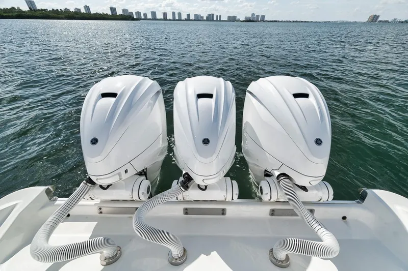 Mo Jack Yacht Photos Pics Triple outboard engines on a 2022 HCB Lujo boat, cruising on open water.
