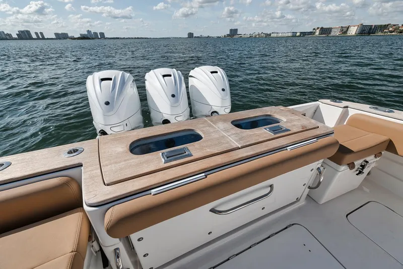 Mo Jack Yacht Photos Pics 2022 HCB Lujo boat with triple outboard engines on a calm sea.