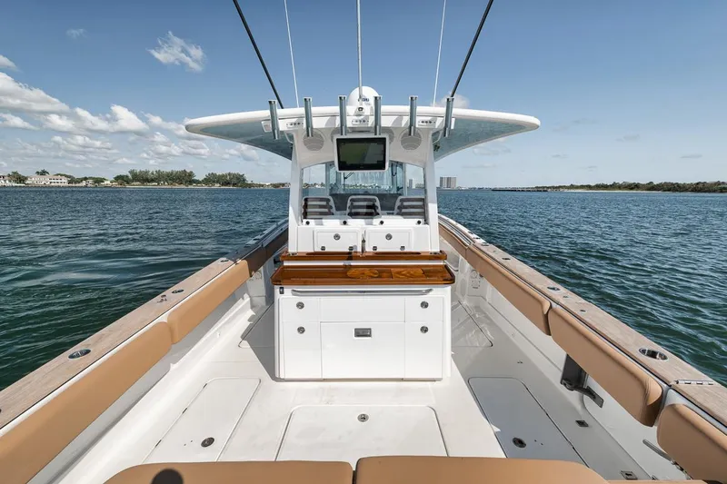 Mo Jack Yacht Photos Pics 2022 HCB Lujo boat interior with seating and helm, cruising on a sunny day.