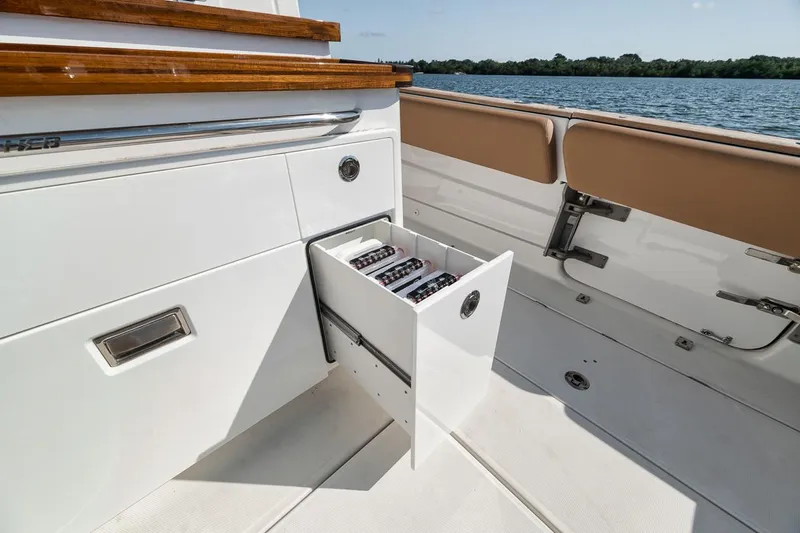 Mo Jack Yacht Photos Pics 2022 HCB Lujo boat with open storage drawer, showcasing sleek design and functionality.