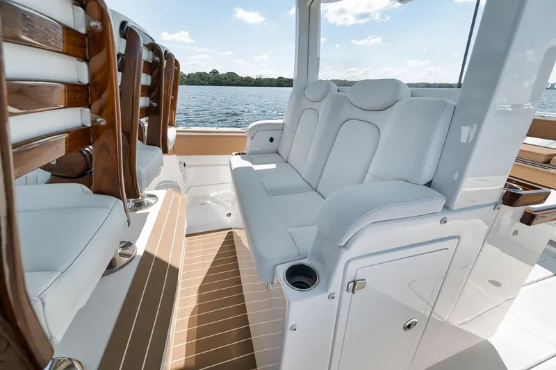 Mo Jack Yacht Photos Pics Luxurious seating on 2022 HCB Lujo boat with elegant wood accents and water view.