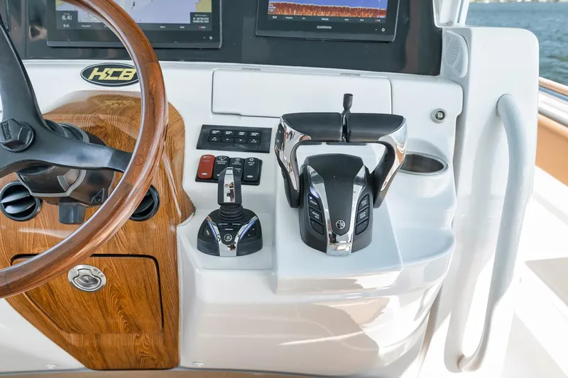 Mo Jack Yacht Photos Pics Helm of 2022 HCB Lujo boat with modern controls and wooden accents.