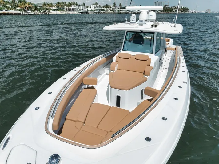 Mo Jack Yacht Photos Pics 2022 HCB Lujo boat with tan seating, cruising on calm waters.