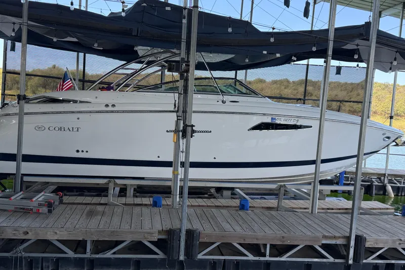  Yacht Photos Pics 2018 Cobalt R35 boat docked, side view with American flag, under canopy.