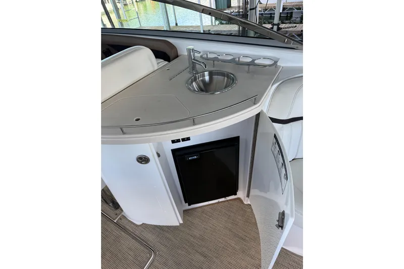  Yacht Photos Pics Compact kitchenette on 2018 Cobalt R35 boat with sink and mini fridge.