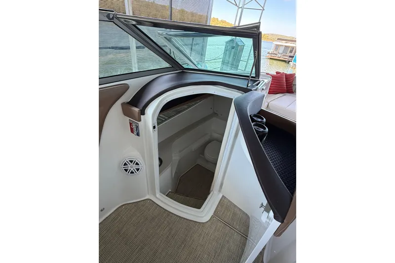  Yacht Photos Pics Interior view of 2018 Cobalt R35 boat cabin with open door and seating area.