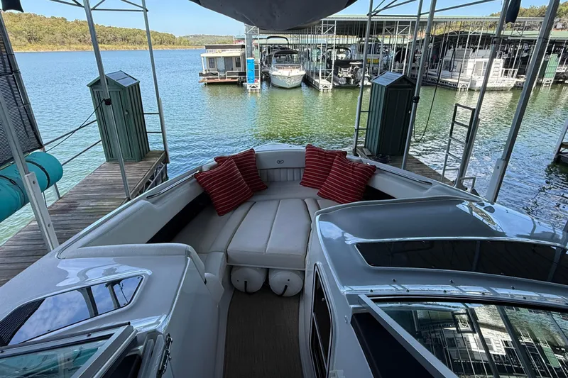  Yacht Photos Pics 2018 Cobalt R35 boat interior with red cushions, docked at a marina.
