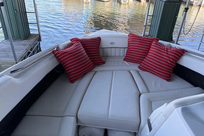  Yacht Photos Pics 2018 Cobalt R35 boat interior with red striped cushions, docked by the water.