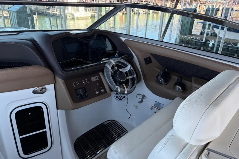  Yacht Photos Pics Interior of a 2018 Cobalt R35 boat with steering wheel and control panel.
