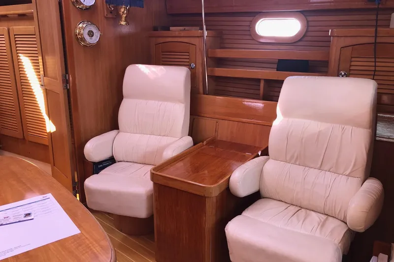Charmed Life Yacht Photos Pics Interior of 2000 Catalina 470 yacht with plush seating and wooden finishes.