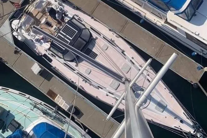 Charmed Life Yacht Photos Pics Overhead view of a 2000 Catalina 470 sailboat docked at a marina.