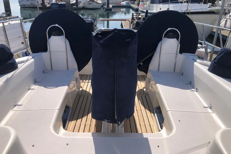 Charmed Life Yacht Photos Pics Cockpit of a 2000 Catalina 470 sailboat with covered steering wheels and seating.