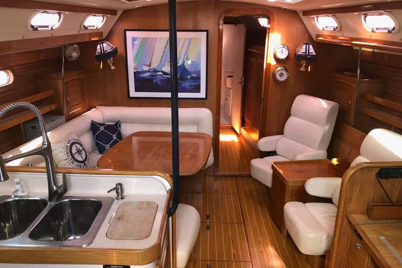 Charmed Life Yacht Photos Pics Interior of a 2000 Catalina 470 yacht with wooden furnishings and cozy seating.