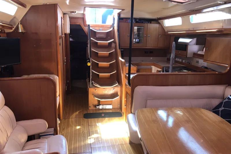 Charmed Life Yacht Photos Pics Interior of a 2000 Catalina 470 yacht with wooden furnishings and cozy seating.