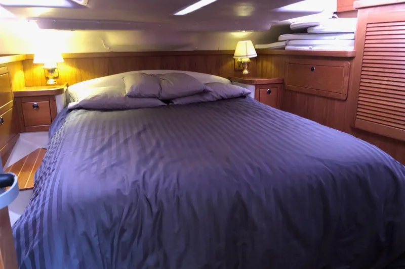 Charmed Life Yacht Photos Pics Cozy bedroom in a 2000 Catalina 470 yacht with elegant wood paneling.