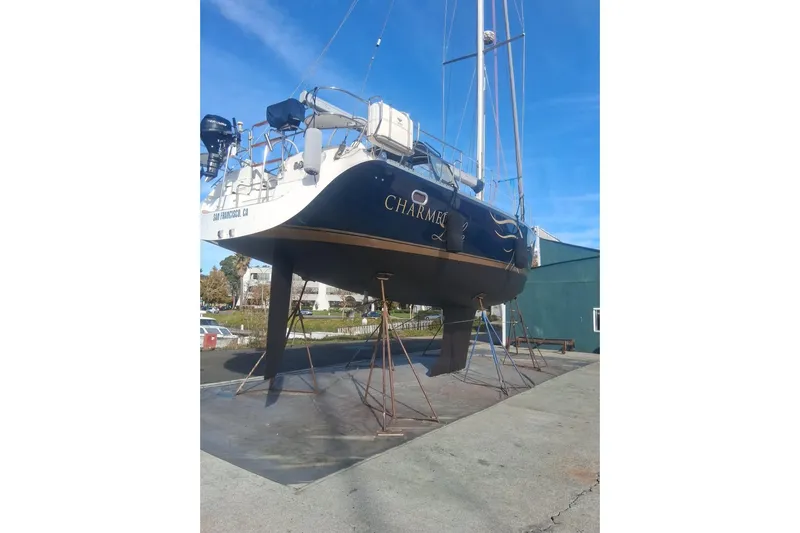 Charmed Life Yacht Photos Pics Catalina 470 sailboat from 2000 on dry dock, San Francisco, blue hull, clear sky.