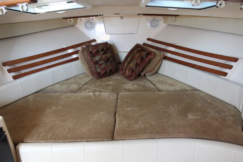 Tide Traveler Yacht Photos Pics 2008 Grady-White Express 330 cabin interior with cozy bedding and decorative pillows.