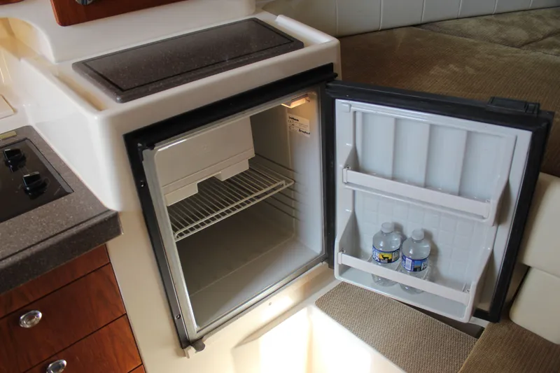 Tide Traveler Yacht Photos Pics 2008 Grady-White Express 330 interior with open mini fridge and water bottles.