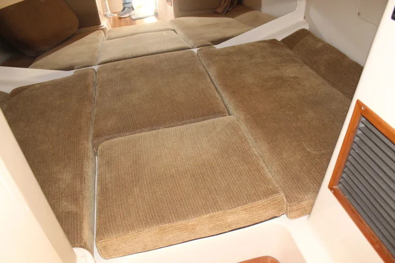 Tide Traveler Yacht Photos Pics 2008 Grady-White Express 330 cabin interior with brown cushioned seating.