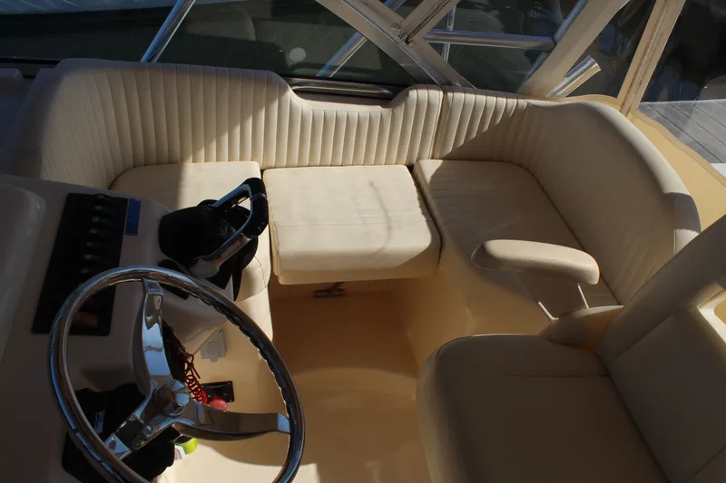 Tide Traveler Yacht Photos Pics 2008 Grady-White Express 330 boat interior with steering wheel and cushioned seating.