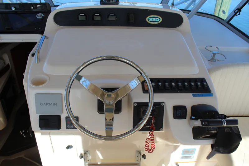 Tide Traveler Yacht Photos Pics 2008 Grady-White Express 330 helm with Garmin navigation and steering wheel.