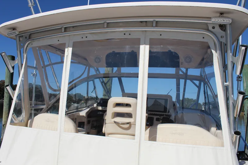 Tide Traveler Yacht Photos Pics 2008 Grady-White Express 330 boat cockpit with clear enclosure and helm station.
