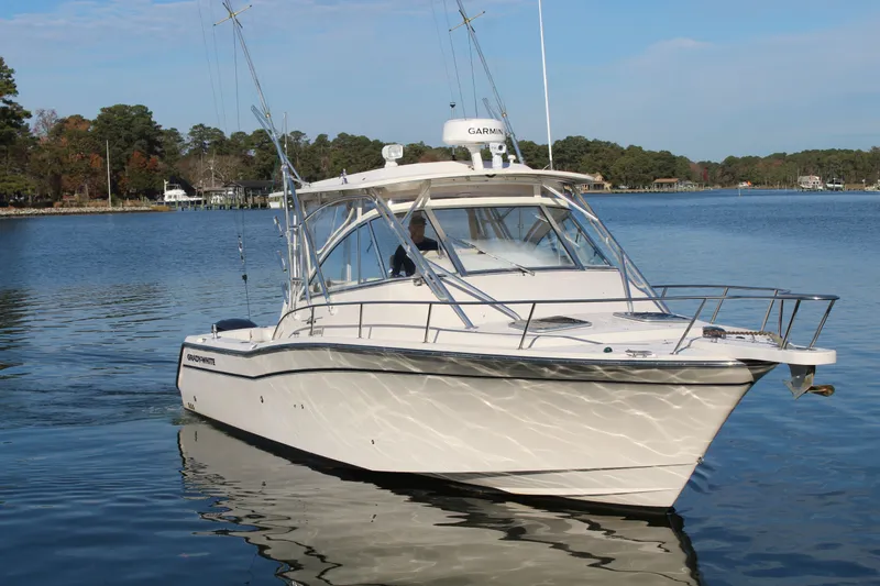 Tide Traveler Yacht Photos Pics 2008 Grady-White Express 330 boat on calm lake with trees in background.