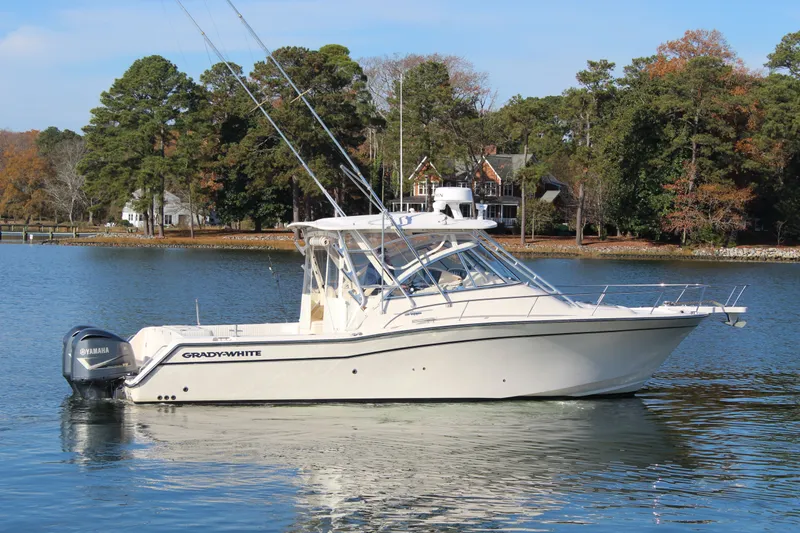 Tide Traveler Yacht Photos Pics 2008 Grady-White Express 330 boat on calm water with scenic forest background.