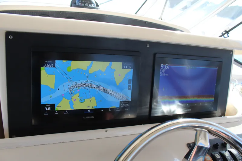 Tide Traveler Yacht Photos Pics Dual Garmin displays on 2008 Grady-White Express 330 boat dashboard showing navigation and sonar.