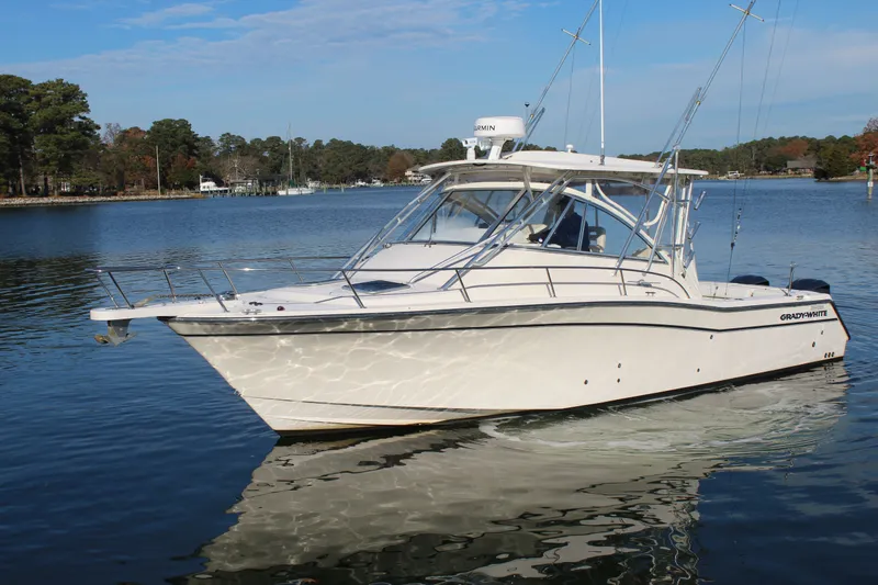 Tide Traveler Yacht Photos Pics 2008 Grady-White Express 330 boat on calm water, surrounded by trees.
