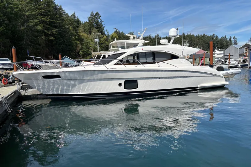 Dolce Far Niente Yacht Photos Pics 2012 Maritimo C53 Sports Cabriolet yacht docked in a serene marina setting.