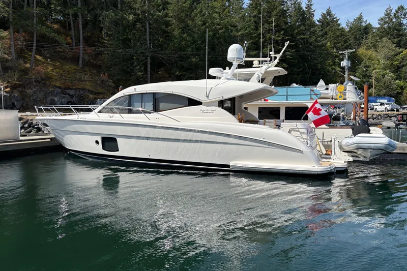 Dolce Far Niente Yacht Photos Pics 2012 Maritimo C53 Sports Cabriolet yacht docked, featuring sleek design and Canadian flag.