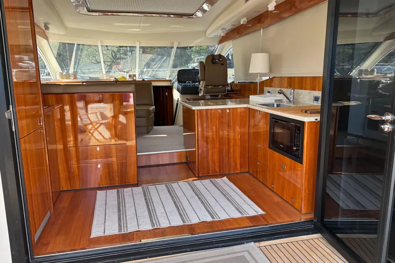 Dolce Far Niente Yacht Photos Pics Interior of 2012 Maritimo C53 Sports Cabriolet yacht with sleek wood finishes and modern amenities.