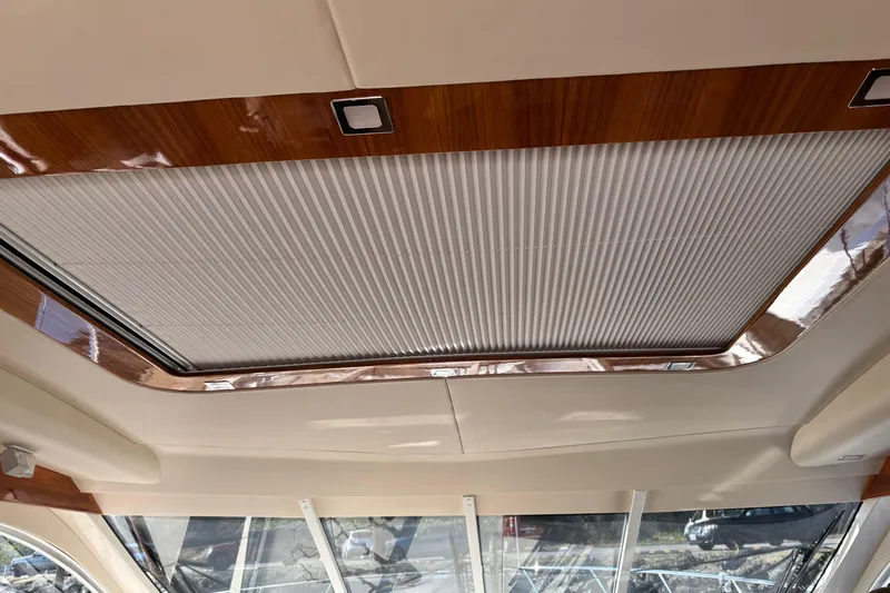 Dolce Far Niente Yacht Photos Pics 2012 Maritimo C53 Sports Cabriolet interior ceiling with wood trim and retractable sunroof.