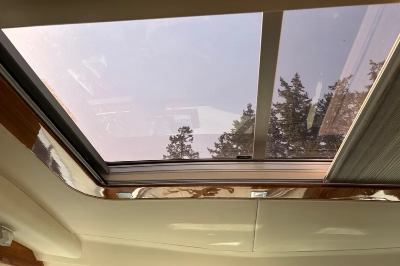 Dolce Far Niente Yacht Photos Pics Sunroof view from 2012 Maritimo C53 Sports Cabriolet, showcasing trees and sky.